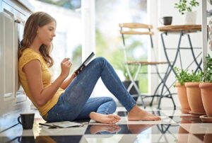 Woman working in a sunroom - Health benefits of a sunroom with natural light