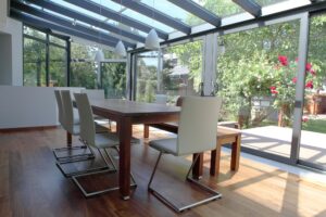 indoor dining room showing dining room table with chairs in a sunroom